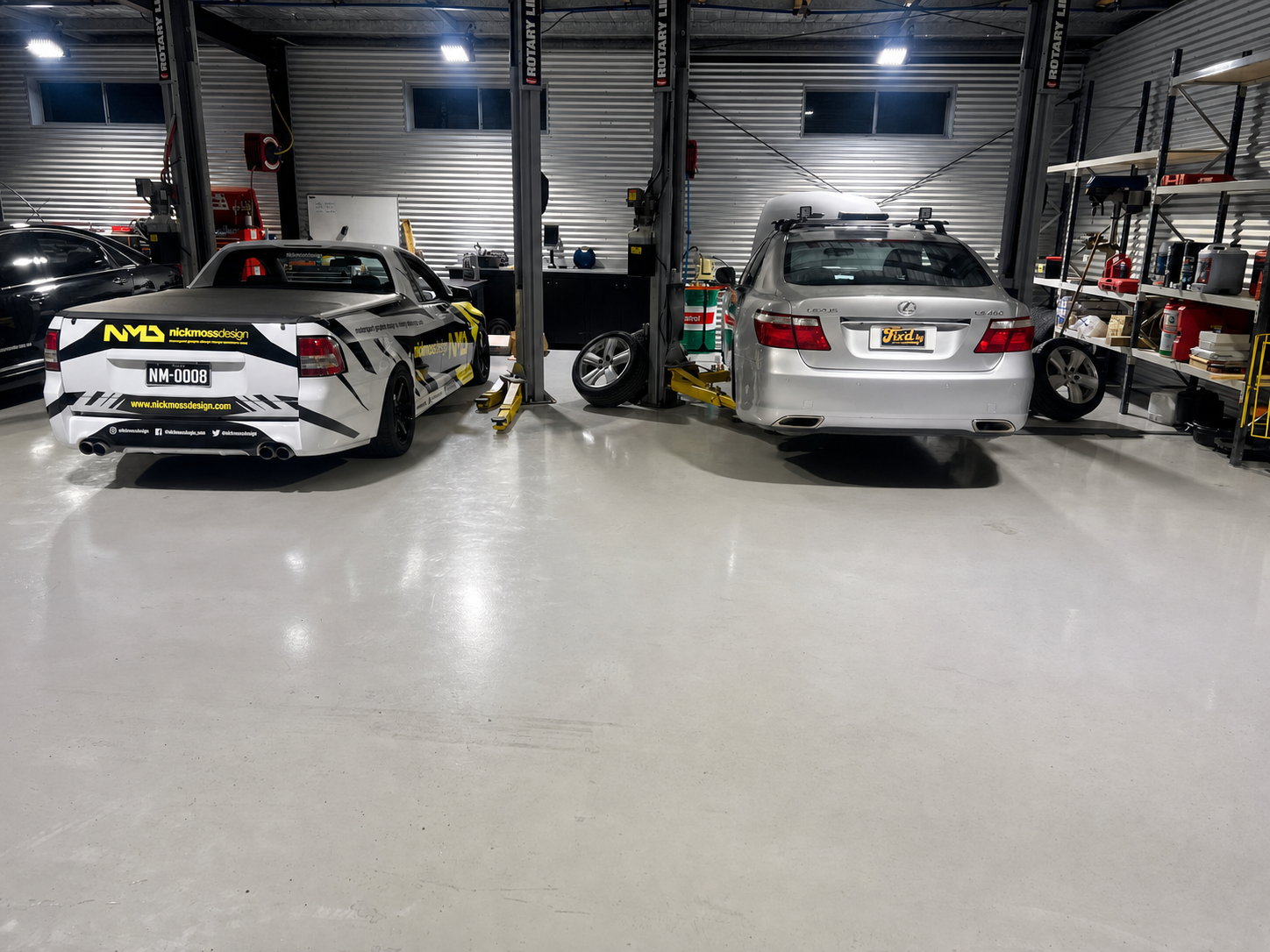 Service bays with vehicles in for work at Fix'd By